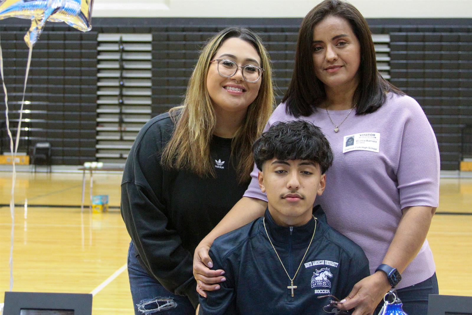 Cypress Park High School senior Andy Barraza, seated, poses with his family after signing a letter of intent to play soccer.